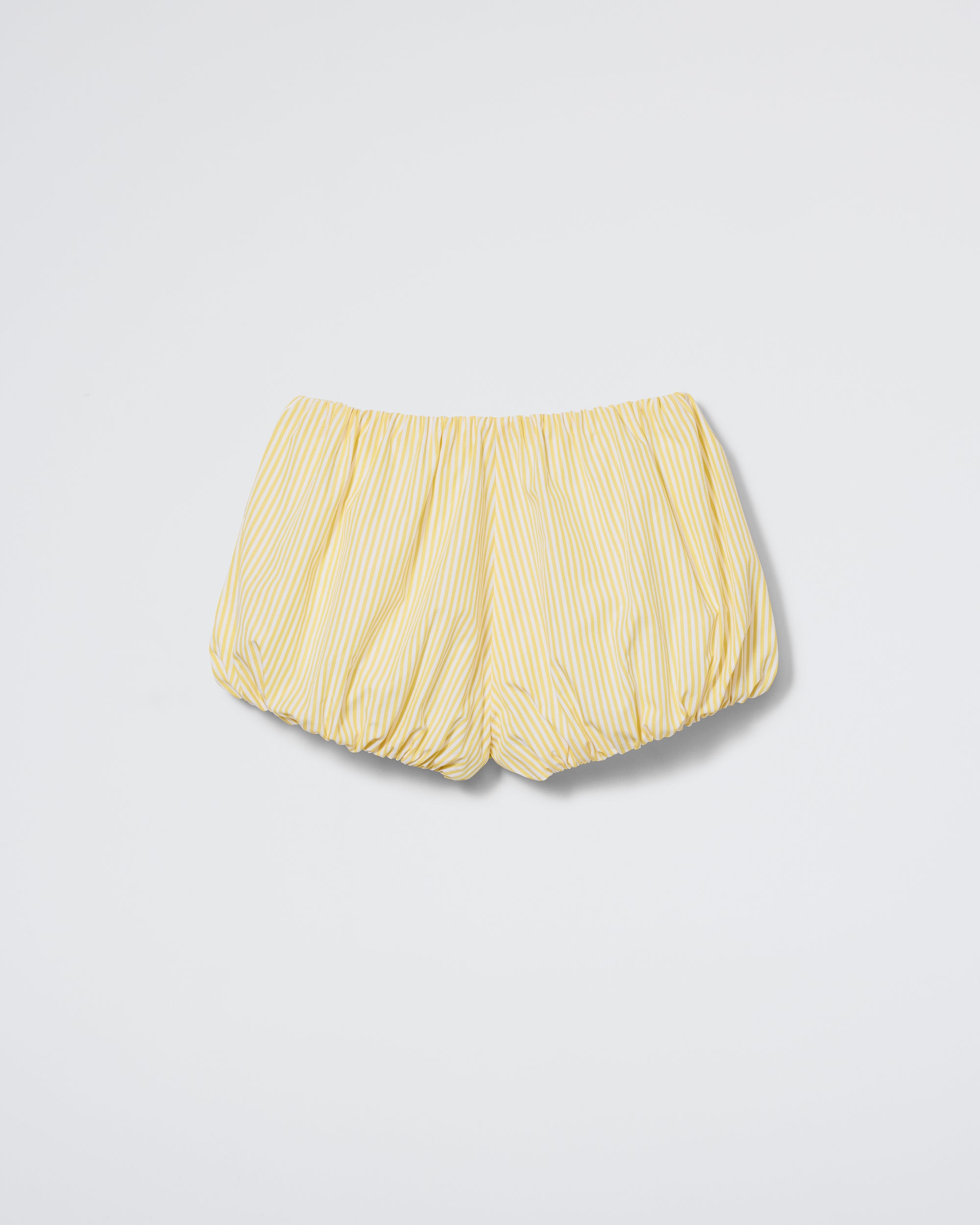 Daphne's The Cloud Bloomer - Sun Stripe shorts feature yellow and white vertical stripes, an elastic waistband, and elasticated leg openings. Laid flat on a white background. Check our size guide for the perfect fit.