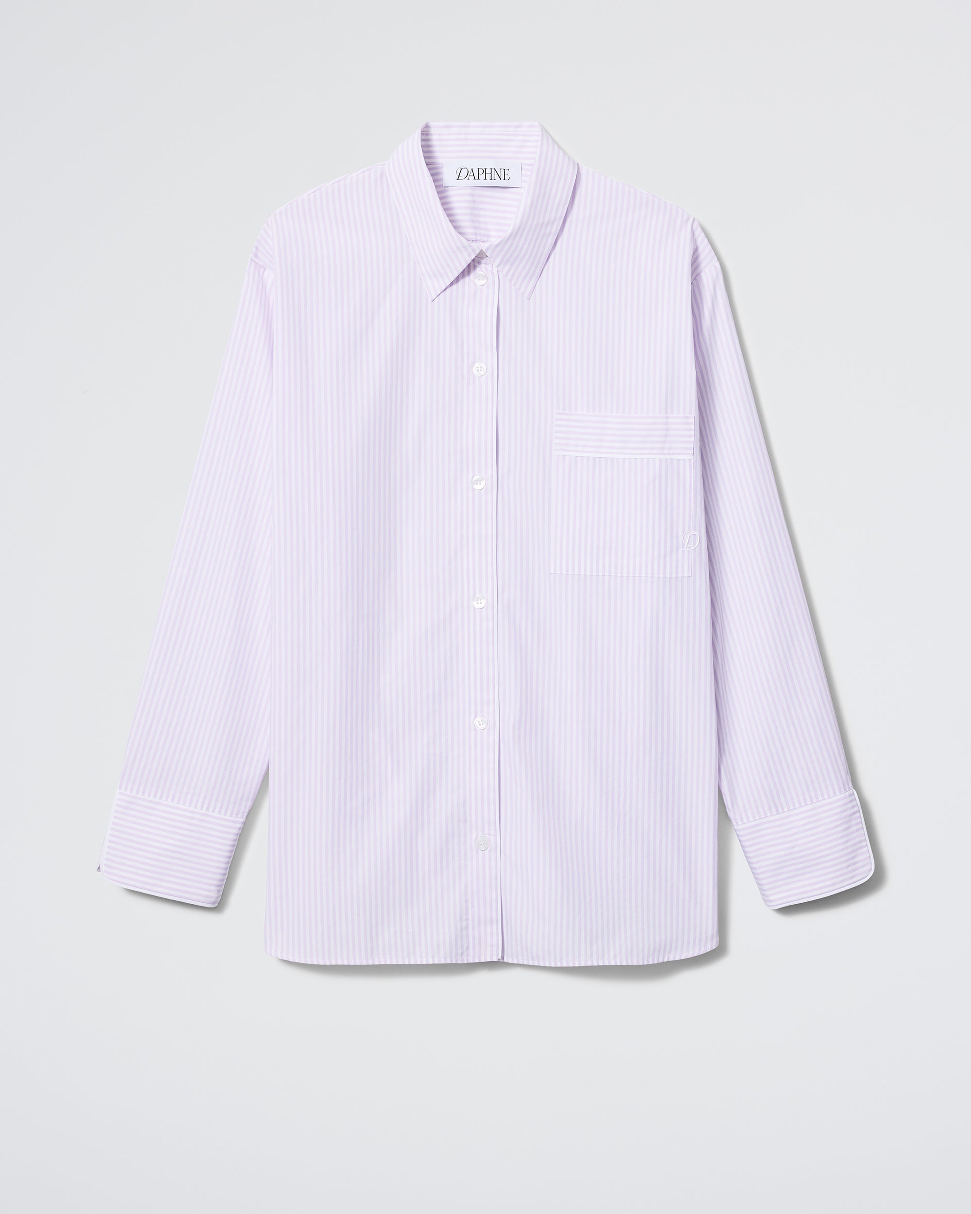 The Daphne Overnight Shirt in Lavender Stripe features light purple and white pinstripes, long sleeves, a collar, and a chest pocket, shown against a plain white background.