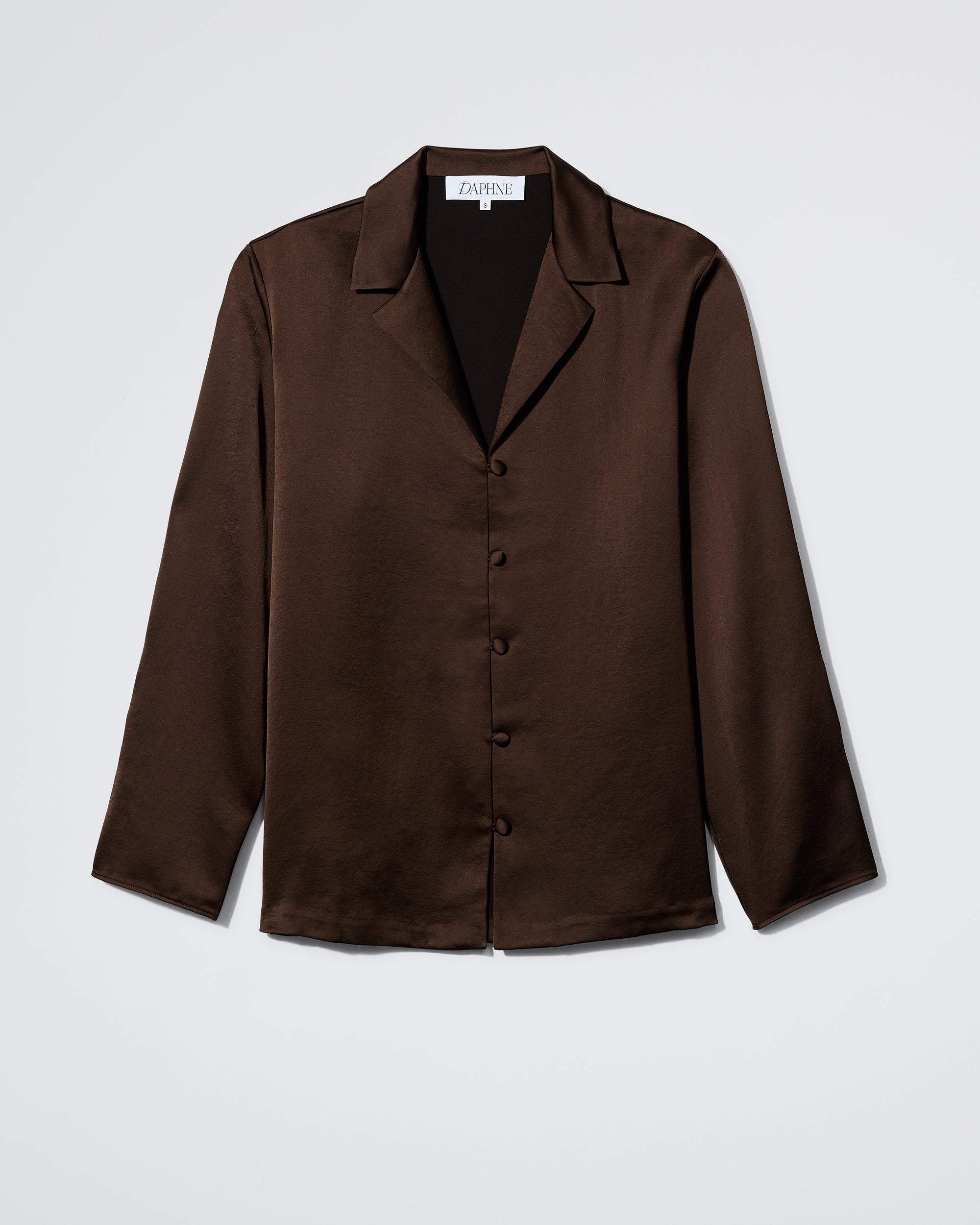 The Daphne Plus One Shirt in Espresso is a long-sleeve, button-up shirt with a notched collar, crafted from shiny dark brown fabric and shown against a plain white background.